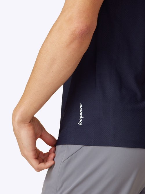 Close-up of the bottom hem and logo on the Loogaroo Gameday Polo in Oceana, accentuating the brand detail