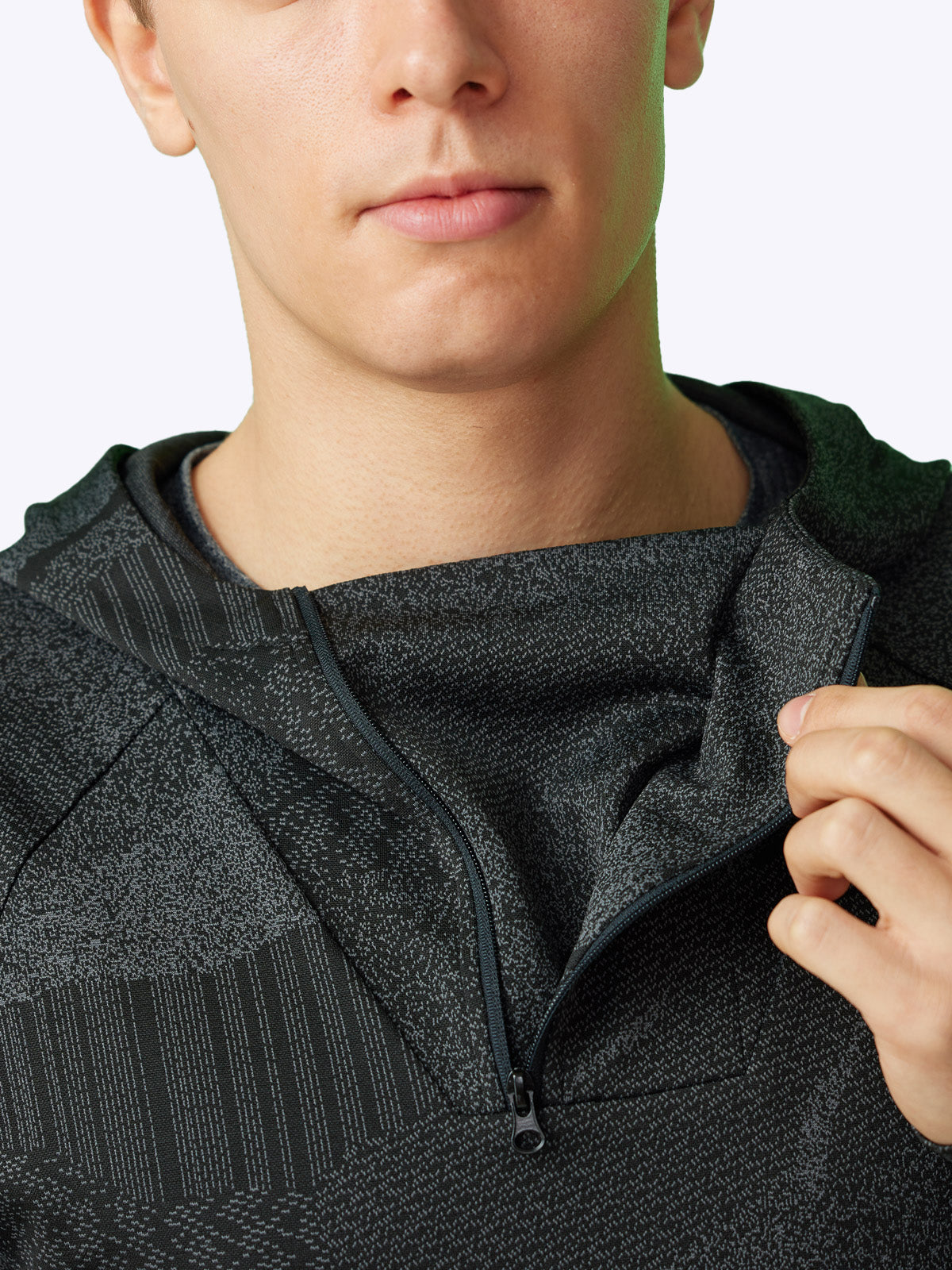 Detailed shot of the Pulse Hoodie's quarter-zip and three-pocket feature for functionality and style||||Onyx