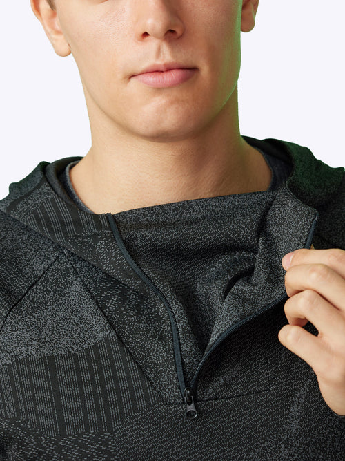 Detailed shot of the Pulse Hoodie's quarter-zip and three-pocket feature for functionality and style