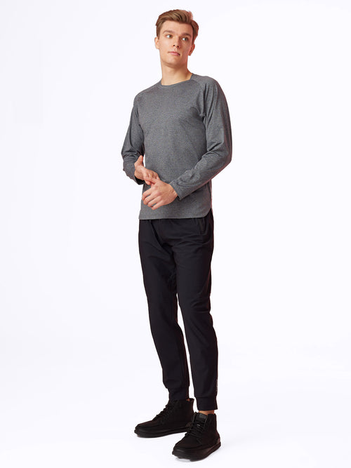 Side view of model in Charcoal Seamfinity Long Sleeve, highlighting the shirt's sleek design