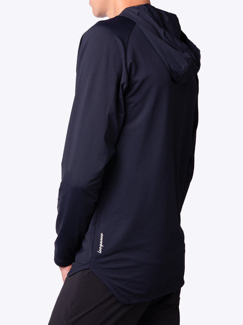 Side back view of a model wearing a lightweight men’s Nexa Hoodie in Oceana Navy by Loogaroo