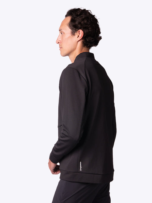 3/4 view of a model wearing a RangeRoamer Jacket in Onyx Black by Loogaroo